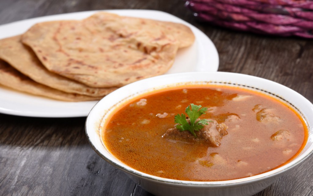 Freshly prepared Nihari served with naan