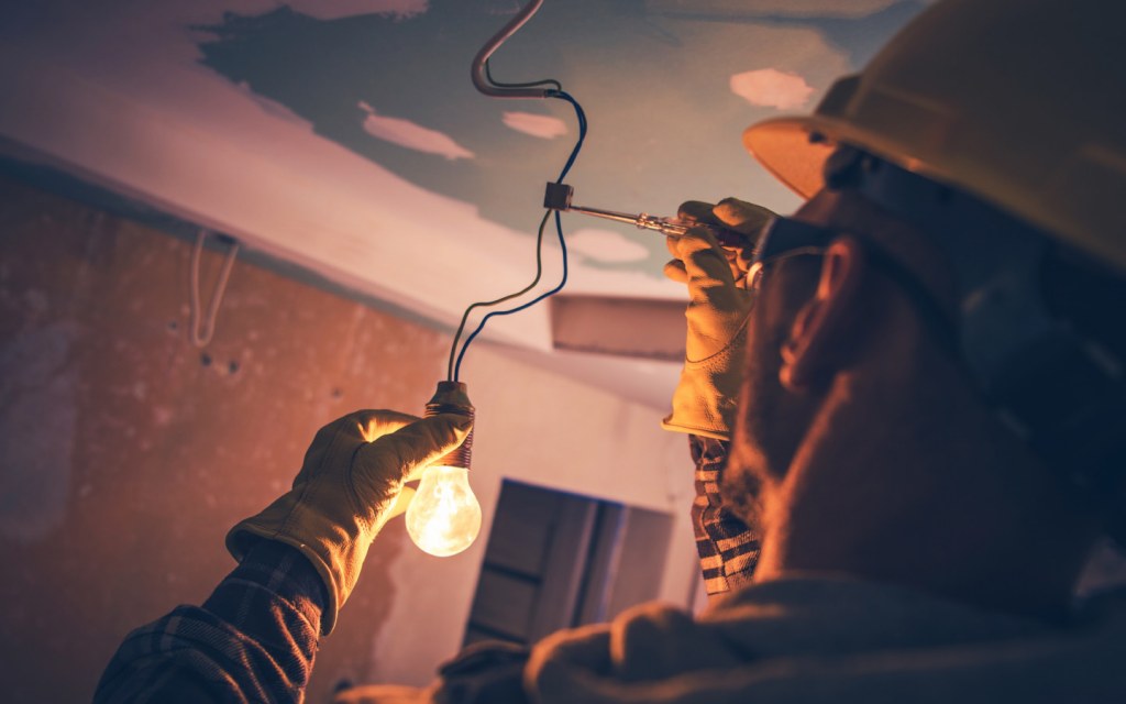 Electrician fixing a light bulb